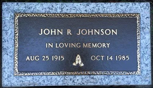 Bronze marker with praying hands on a granite base