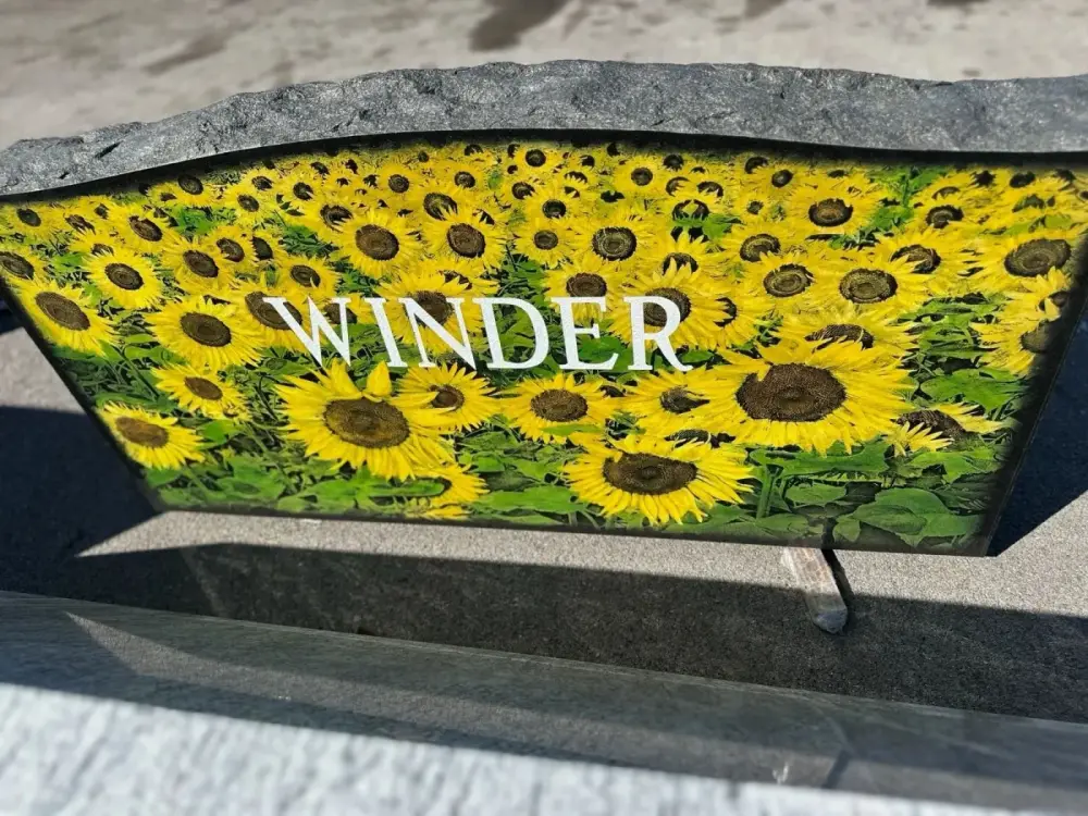Black granite monument with a sunflower field in full color, Winder